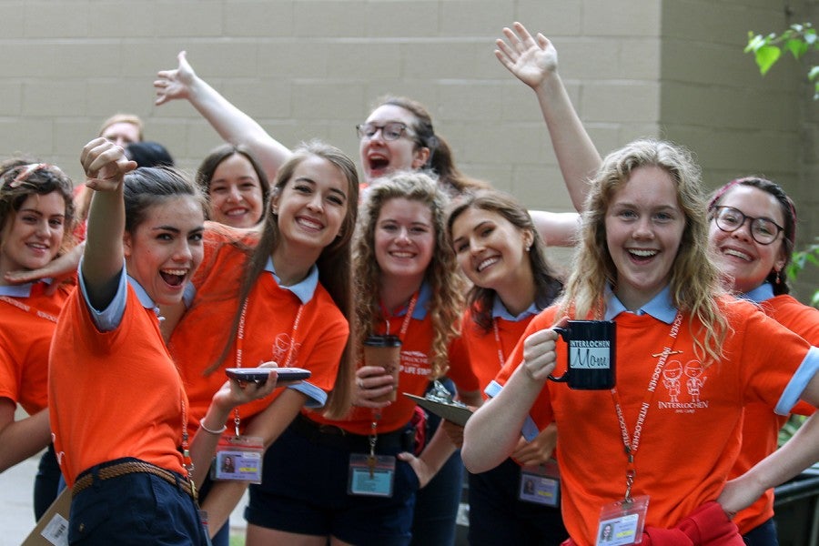 A group of young women in orange t-shirts