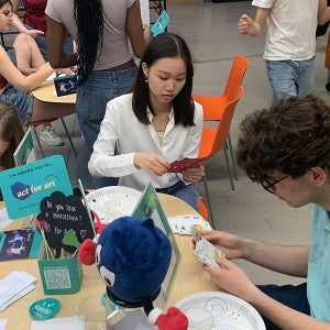 Students write thank-you notes at the 2024 Act for Art kickoff party