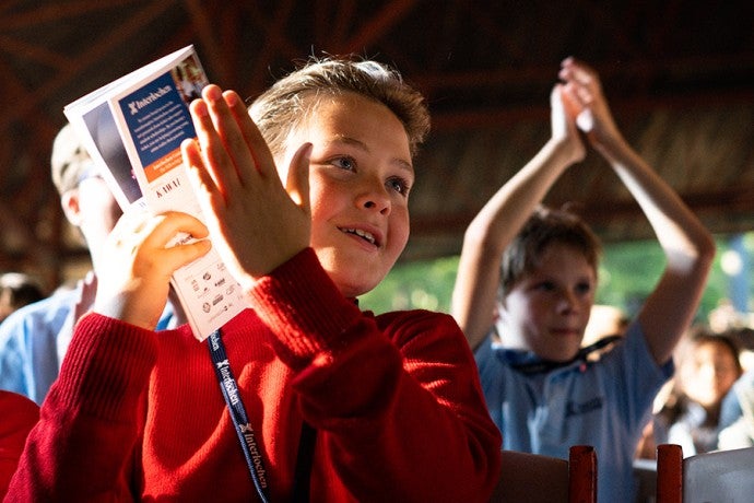 Junior students react to a performance at "Collage."
