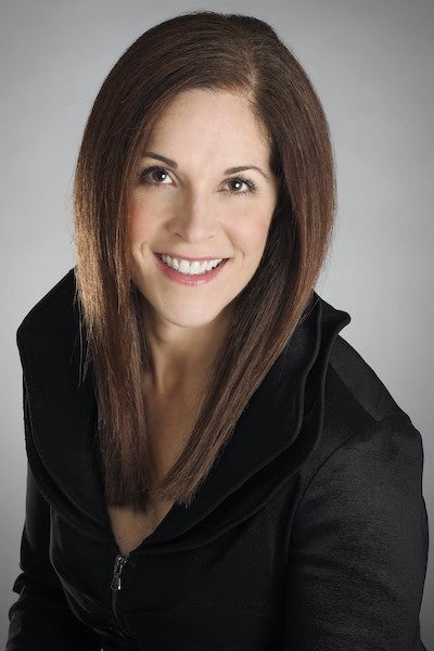 Camp and Academy parent Carolyn Caputo-McCauley wearing a black top and smiling