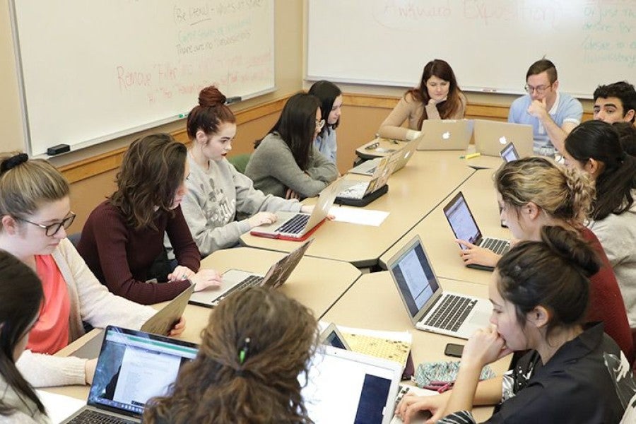 Brittany Cavallaro and Kit Williamson (at head of table) teach "The Poetry of Playwriting" during Inter*mester 2018.