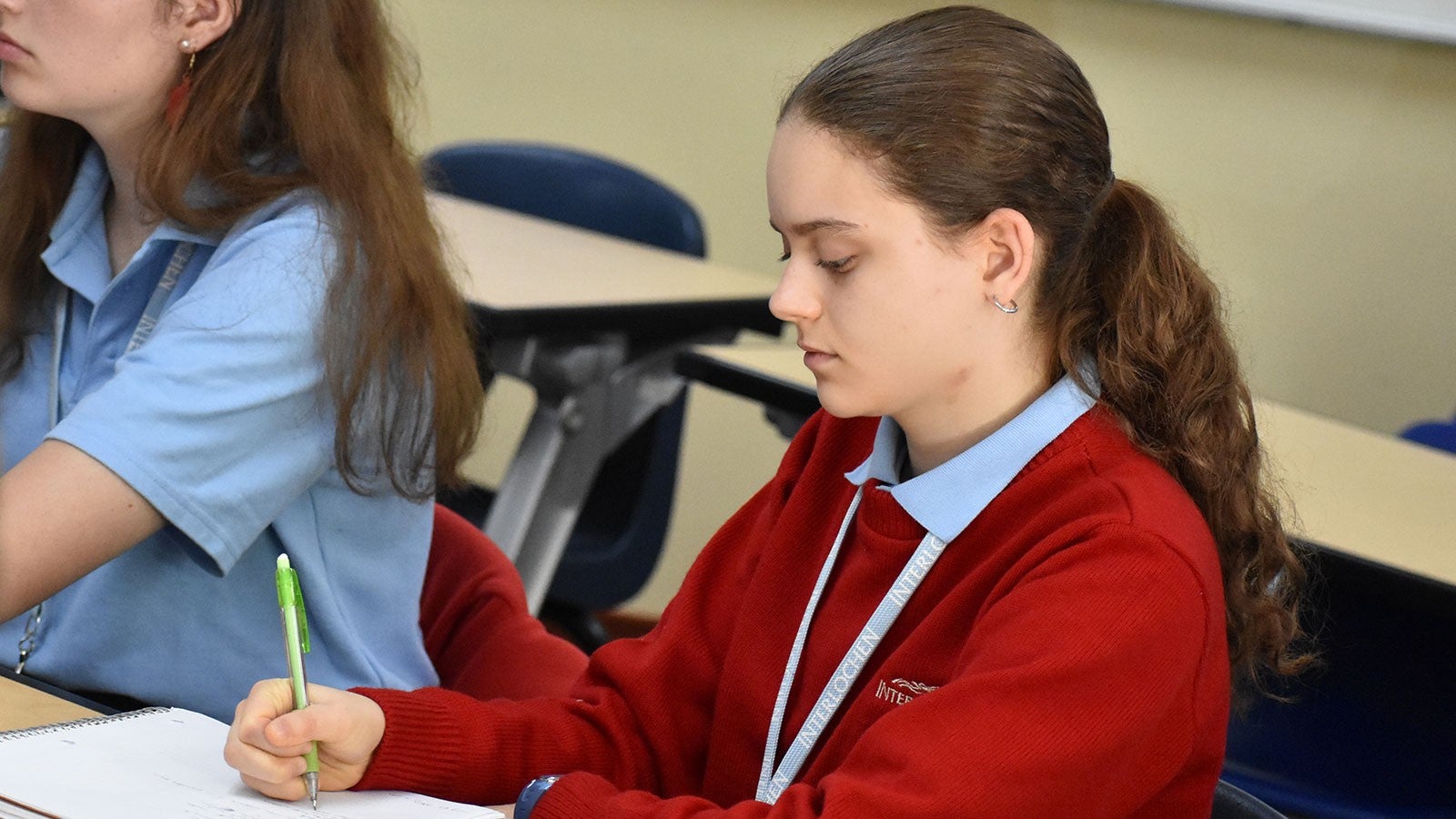 A girl writes music on a manuscript page