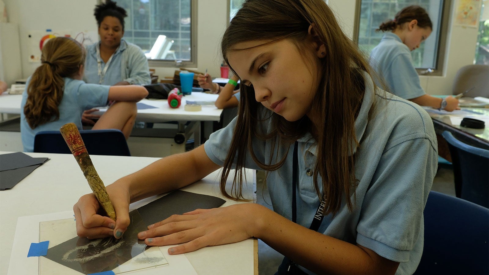 A girl etches a print
