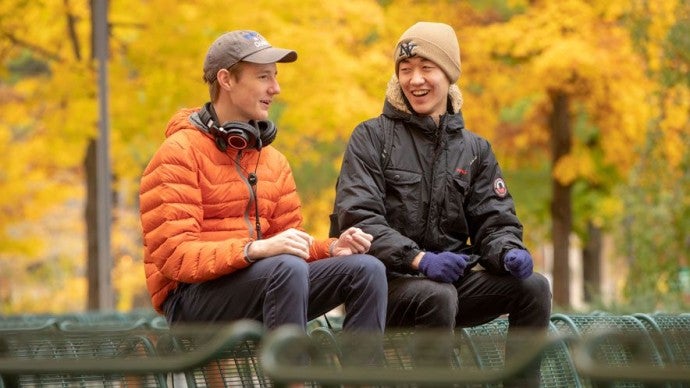 Interlochen Arts Academy students share a conversation on Osterlin Mall