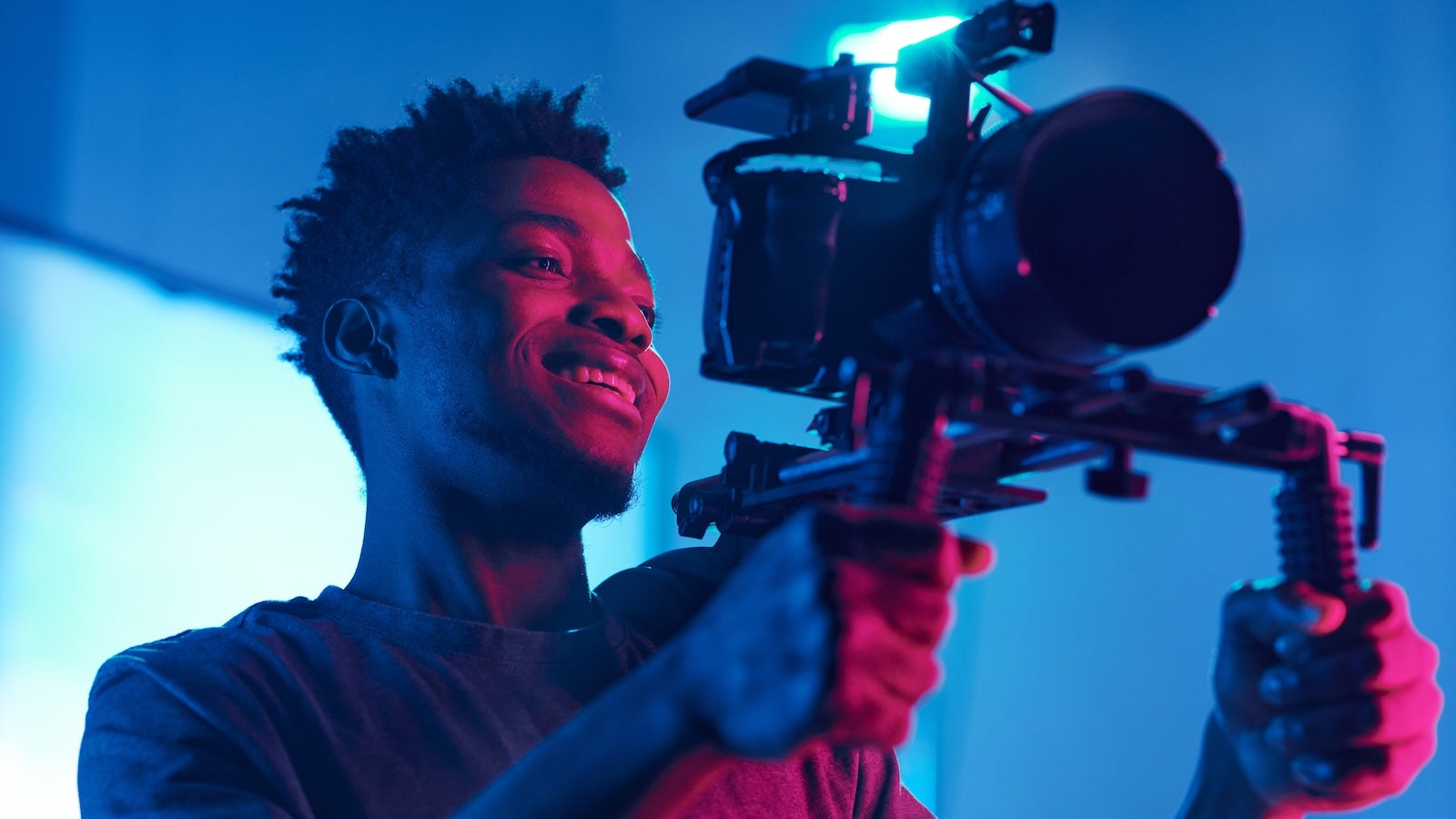 A man holding a camera on set