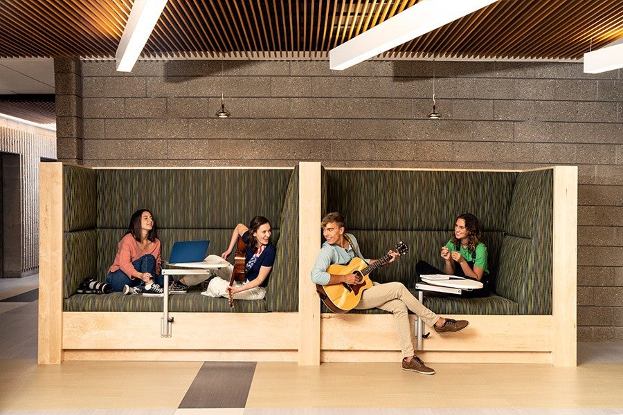 Academy students socializing and working in the music center