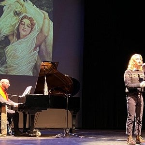 Instructor of Voice Doug Peck accompanies a student performer during the musical cabaret