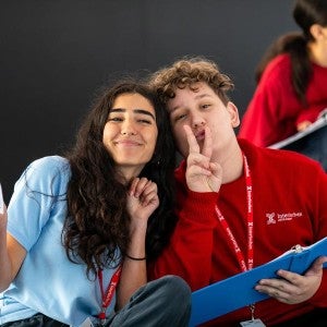 Two Camp musical theatre students smile at the camera.