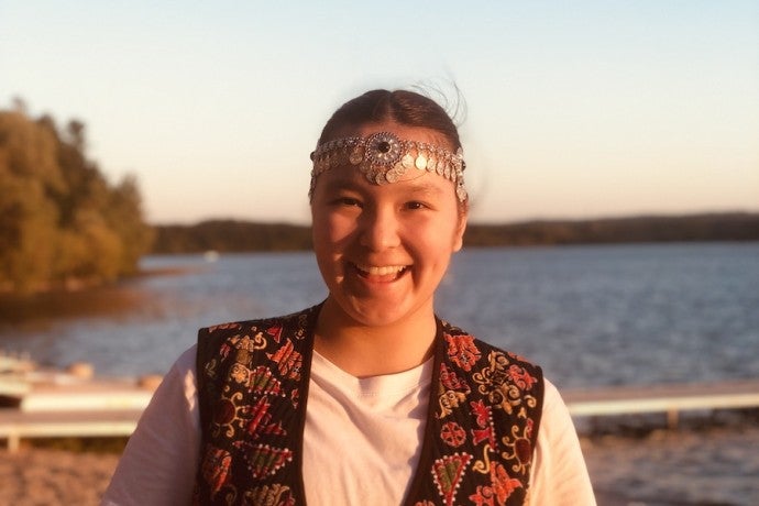 Headshot of Assyl Rassulkyzy in front of a lake