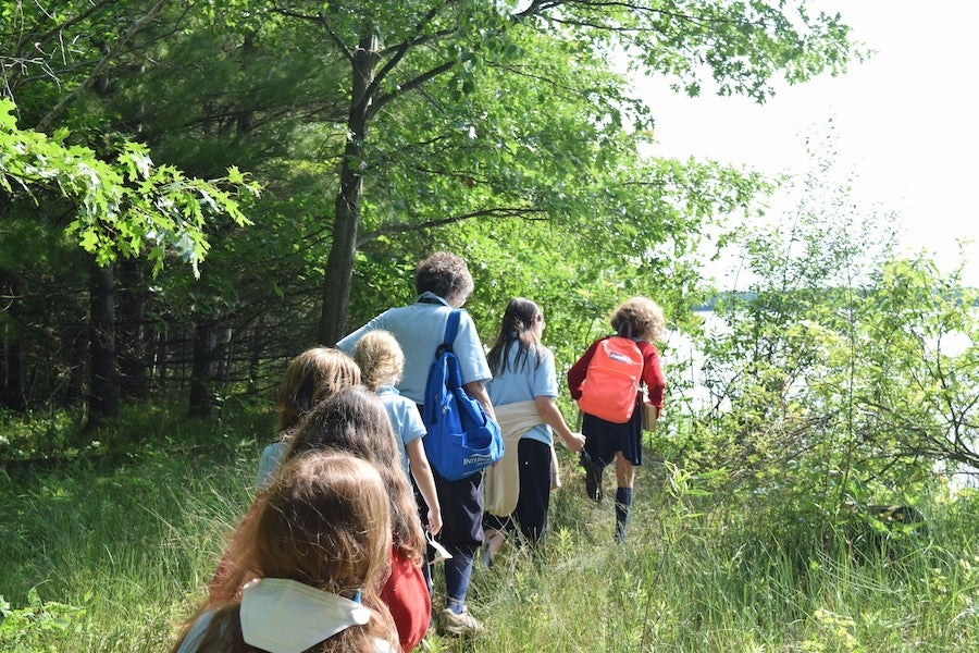 Interdisciplinary Arts Exploration students walk by the lake