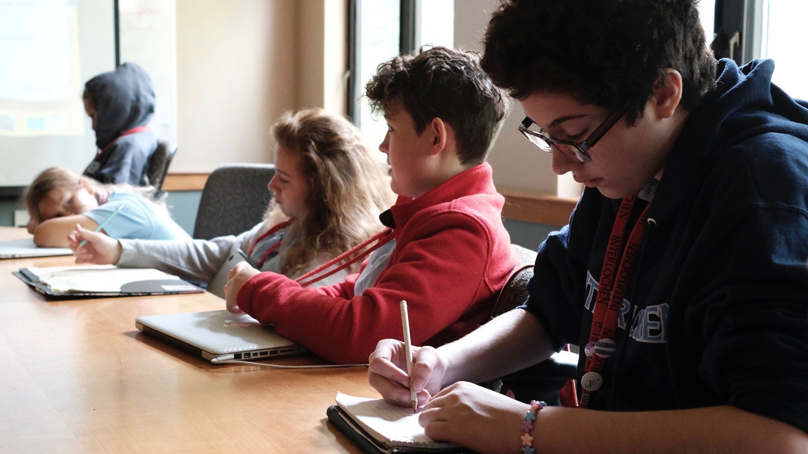 Children writing at a table