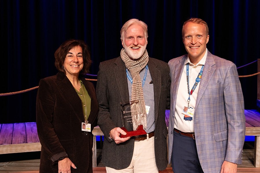 Timothy Johnson poses with Interlochen Provost Camille Colatosti and President Trey Devey after receiving the Lifetime Achievement Award. 