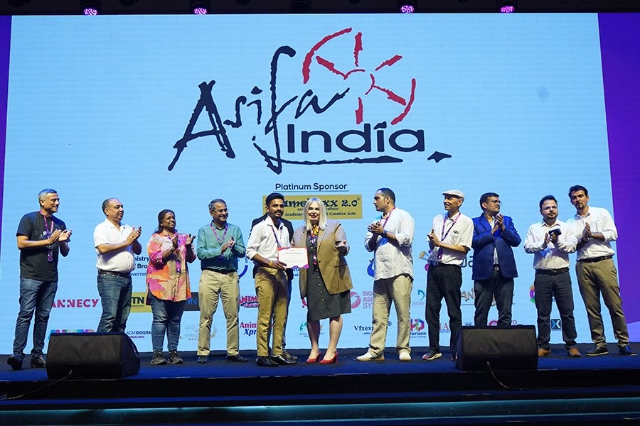 Briana Yarhouse (center, tan blazer) presents an award at WAVES. 